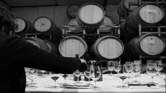 Image of wine casks and tasting table for wine tastings